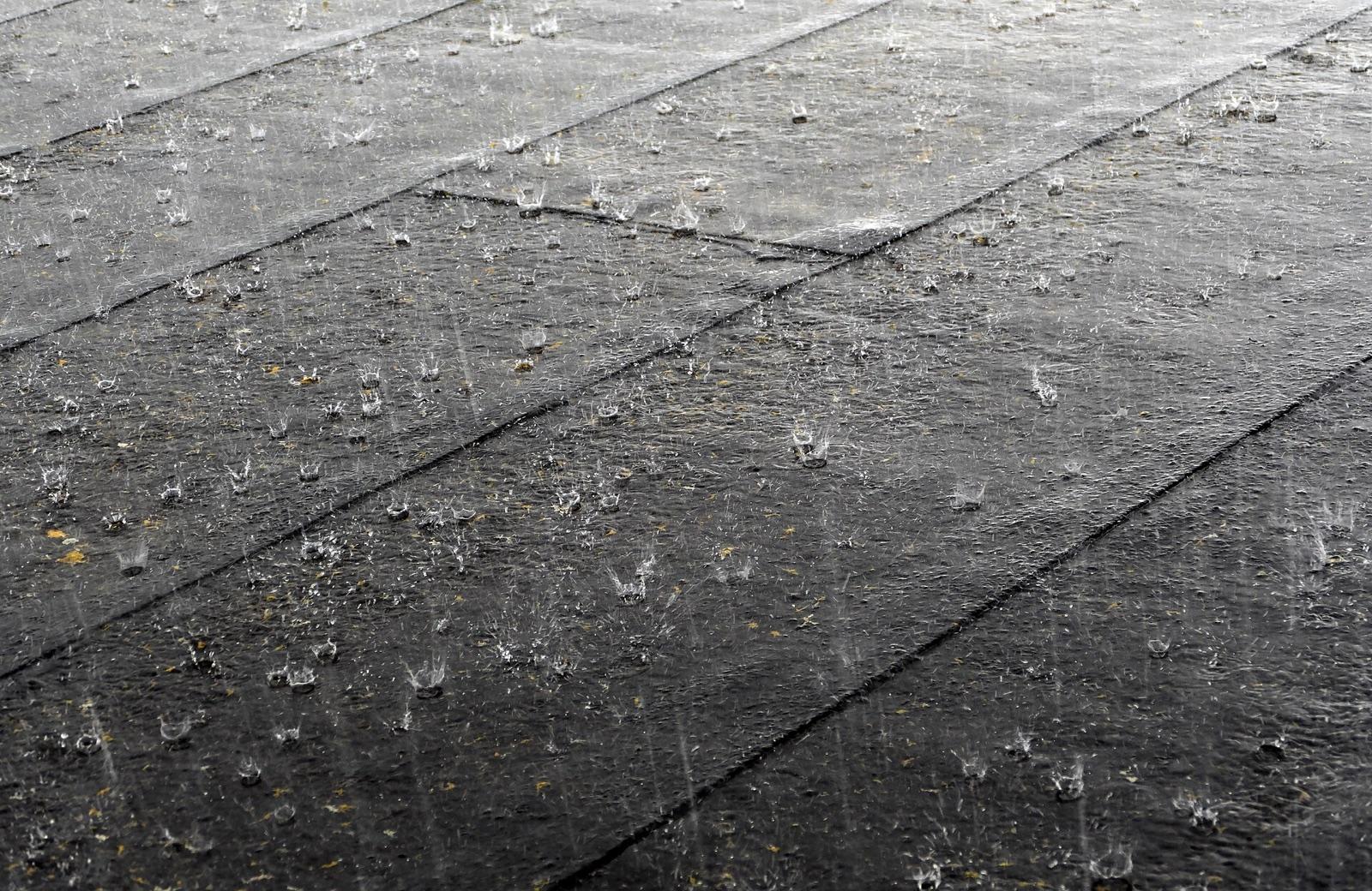Hard rain bouncing off a dark roof, ready to be channeled into a collector