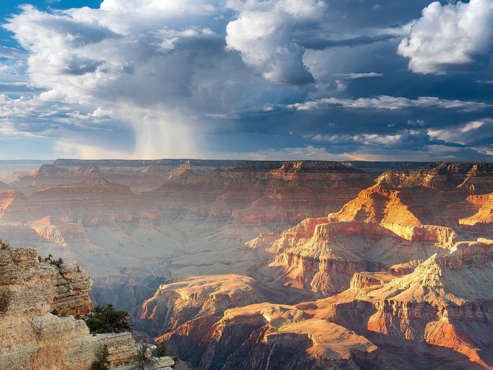 A rain shower falling from storm clouds over the Grand Canyon